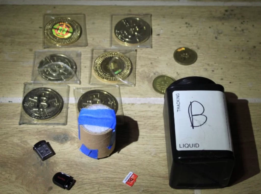 The partial contents of the popcorn can, containing memory cards with billions of cryptocurrency and other precious metals. Image Credits: Justice Dept. (handout)